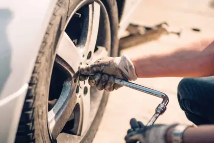 Fitter checking a wheel and tyre for damage before a repair